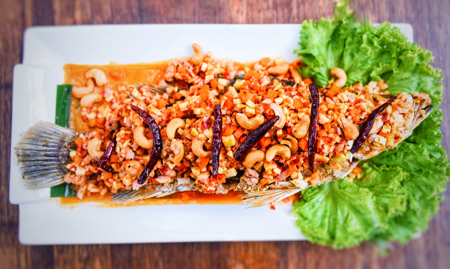 ปลากระพงหลายใจ ( Deep Fried Sea Bass with Mix Seafood Sauce )